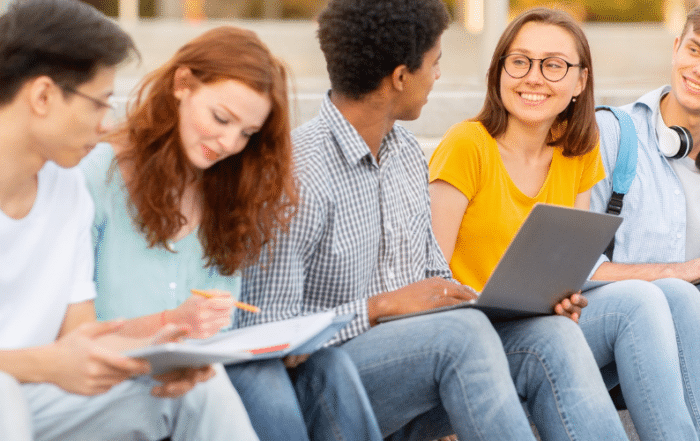 Juniors in high school sitting on stairs outside