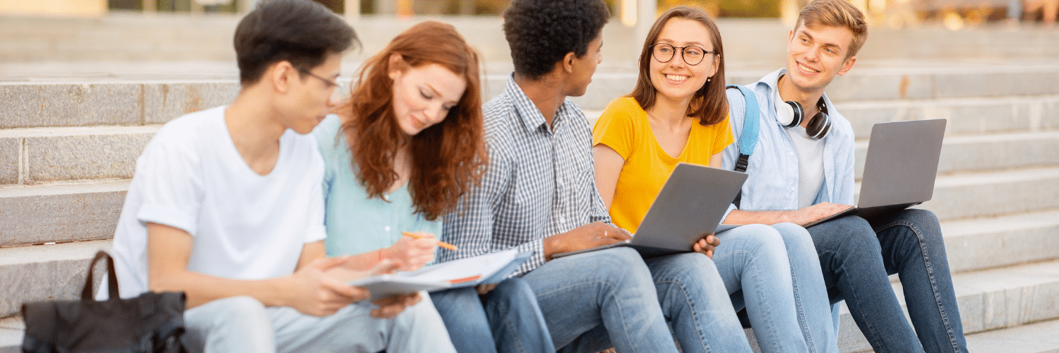 Juniors in high school sitting on stairs outside