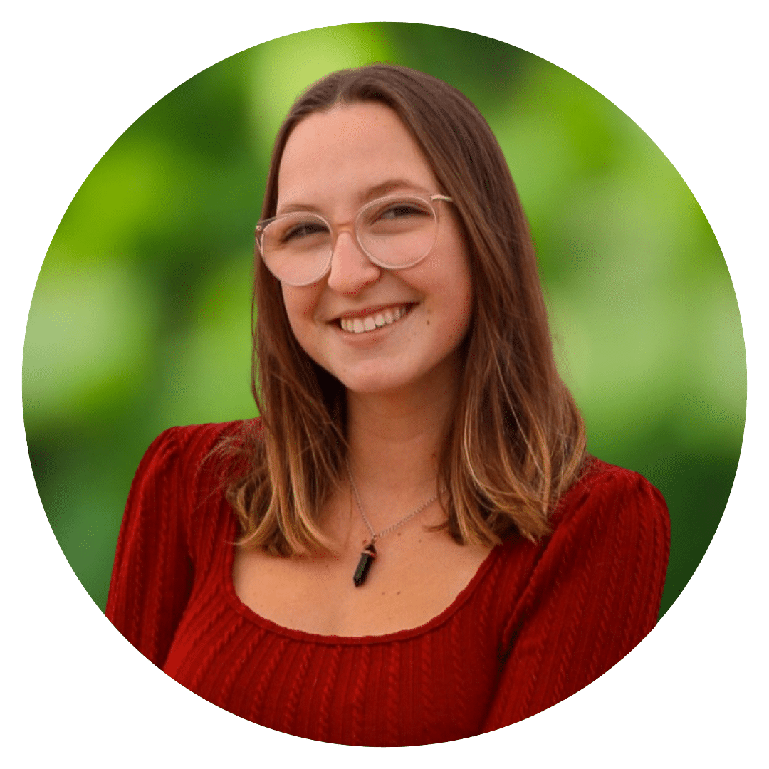 Circle cutout of Mary H.'s professional headshot, with a background of leaves