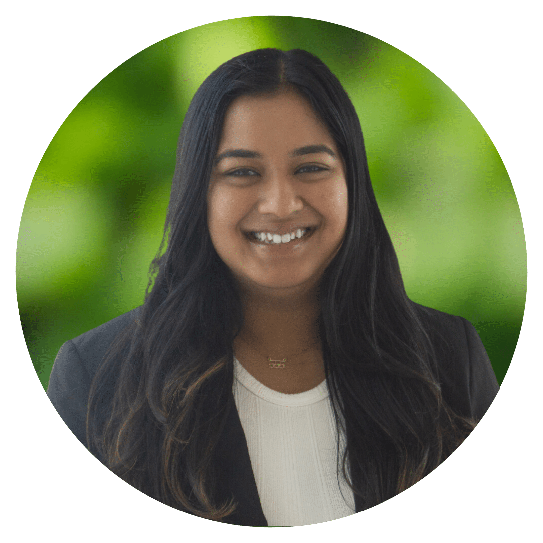 Circle cutout of Nikita B.'s professional headshot, with a background of leaves