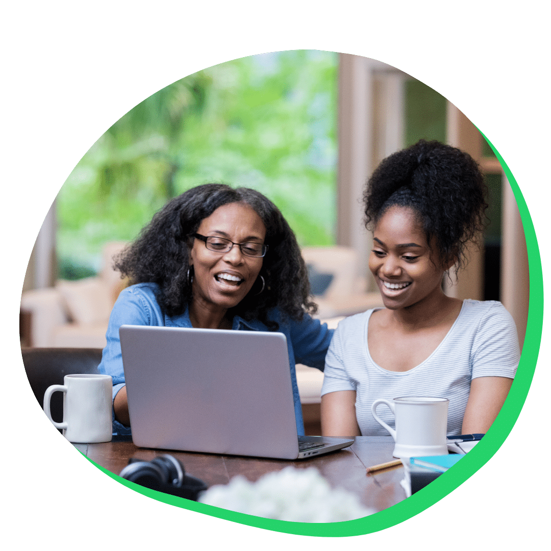 Mother helping her daughter on computer