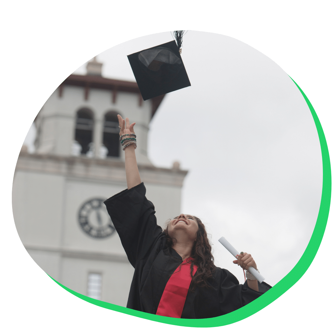 Graduate student throwing her cap up