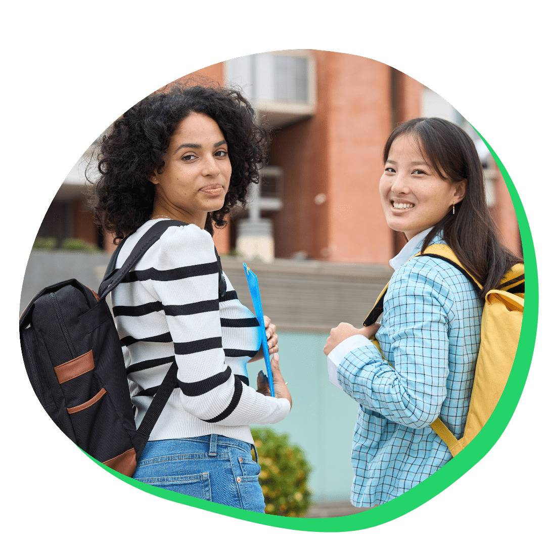 College girl students walking on campus looking back