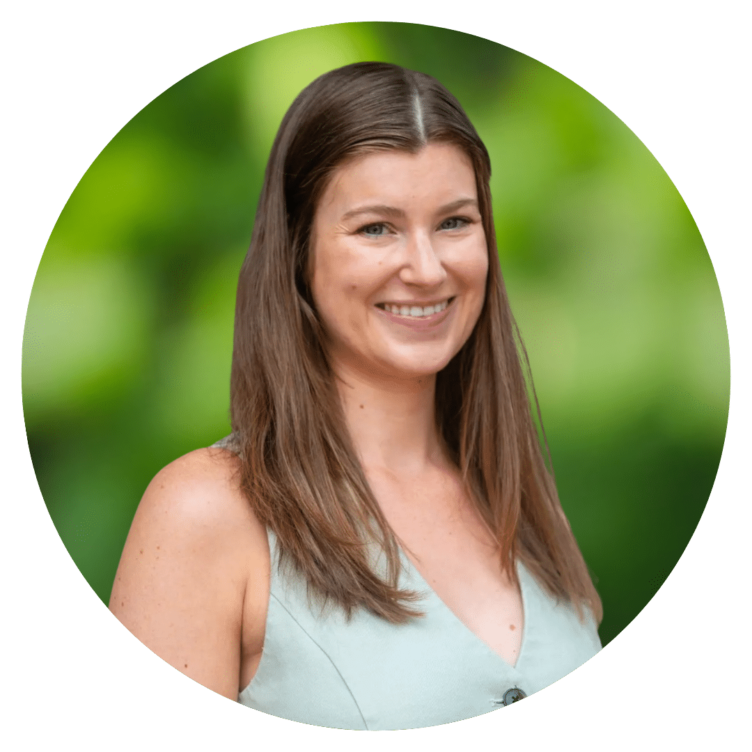 Circle cutout of Emily W.K.'s professional headshot, with a background of leaves