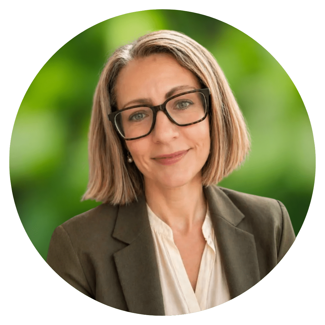 Circle cutout headshot of Prepory Coach Lisa R. behind a blurred background of green leaves